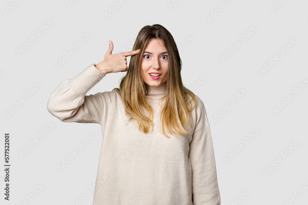 Young blonde posing for a portrait isolated, exuding natural beauty and radiance showing a disappointment gesture with forefinger. Young blonde posing for a portrait isolated, exuding natural beauty and radiance showing a disappointment gesture with forefinger.