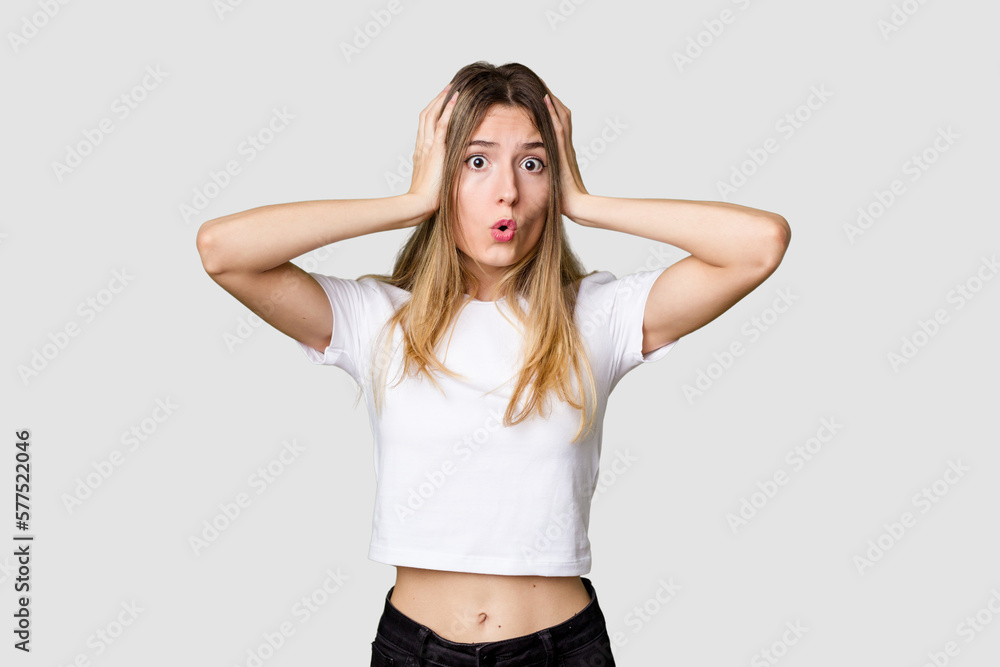 Young blonde posing for a portrait isolated, exuding natural beauty and radiance being shocked, she has remembered important meeting. Young blonde posing for a portrait isolated, exuding natural beauty and radiance being shocked, she has remembered important meeting.