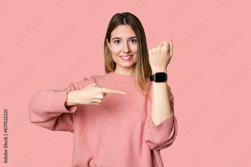A young woman admiring her sleek and modern smartwatch for convenient timekeeping. A young woman admiring her sleek and modern smartwatch for convenient timekeeping.