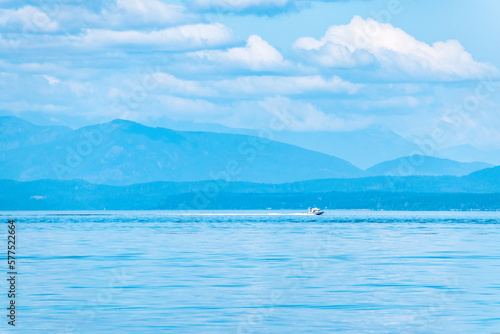 Boat With Tropical Mountains on Summer Day Along Strait of Georgia in Vancouver Island, British Columbia, Canada
