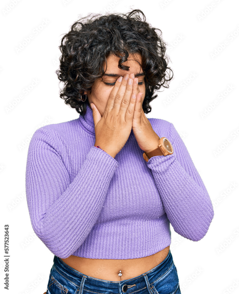 Young hispanic woman with curly hair wearing casual clothes with sad expression covering face with hands while crying. depression concept. Young hispanic woman with curly hair wearing casual clothes with sad expression covering face with hands while crying. depression concept.