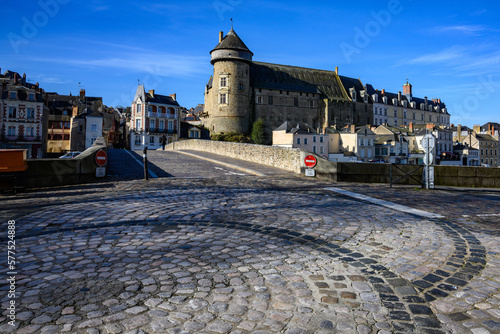 Old bridge over Mayenne River in Laval, France with decorative cobblestones