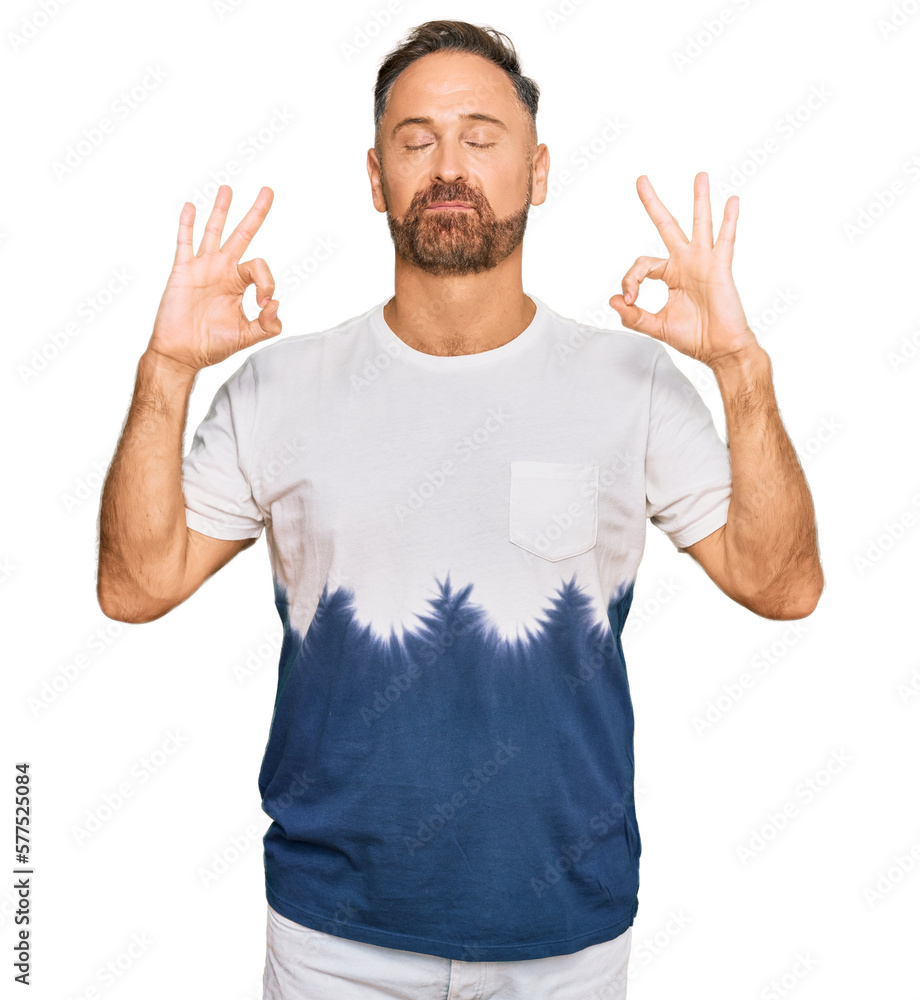 Naklejka premium Handsome middle age man wearing casual tie dye tshirt relax and smiling with eyes closed doing meditation gesture with fingers. yoga concept.