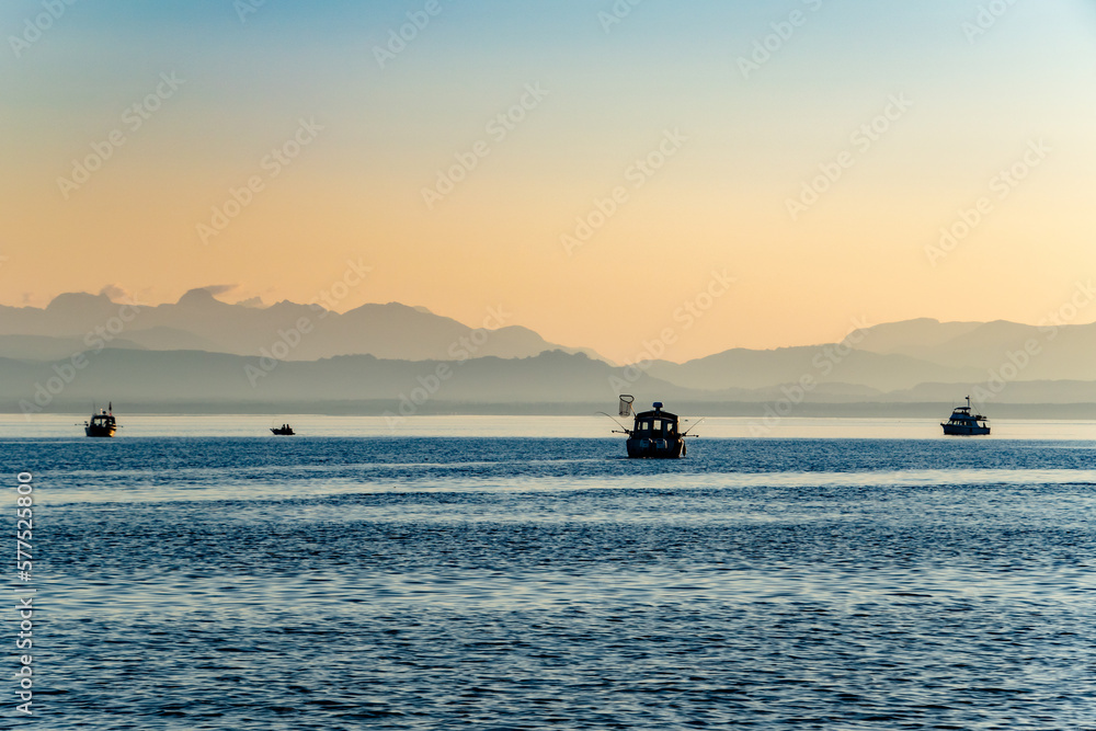 Fishing Boats Getting in the Final Hours of Light at Sunset On Strait of Georgia in Vancouver Island, British Columbia, Canada