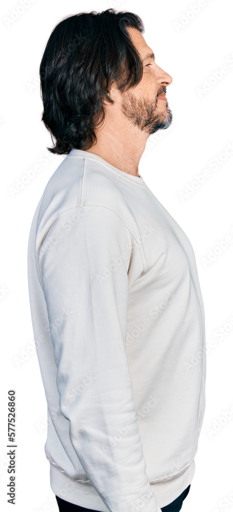 Middle age caucasian man wearing casual clothes looking to side, relax profile pose with natural face and confident smile. Middle age caucasian man wearing casual clothes looking to side, relax profile pose with natural face and confident smile.