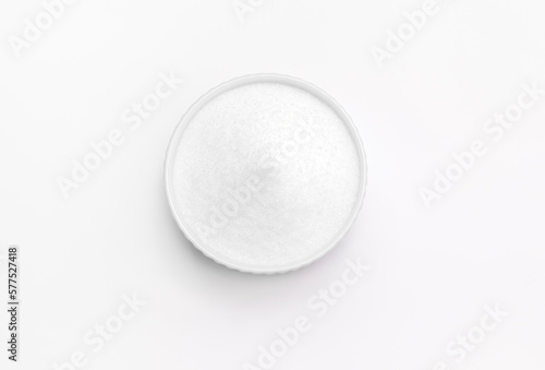 Isolated natural sweetener Erythritol, produced by fermentation from corn, called dextrose in ceramic bowl on white background. Sugar substitute. Horizontal plane, copy space for text,top view