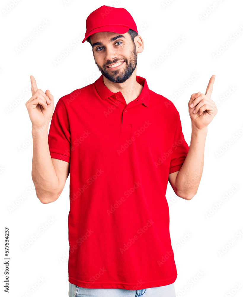 Young handsome man with beard wearing delivery uniform smiling confident pointing with fingers to different directions. copy space for advertisement Young handsome man with beard wearing delivery uniform smiling confident pointing with fingers to different directions. copy space for advertisement