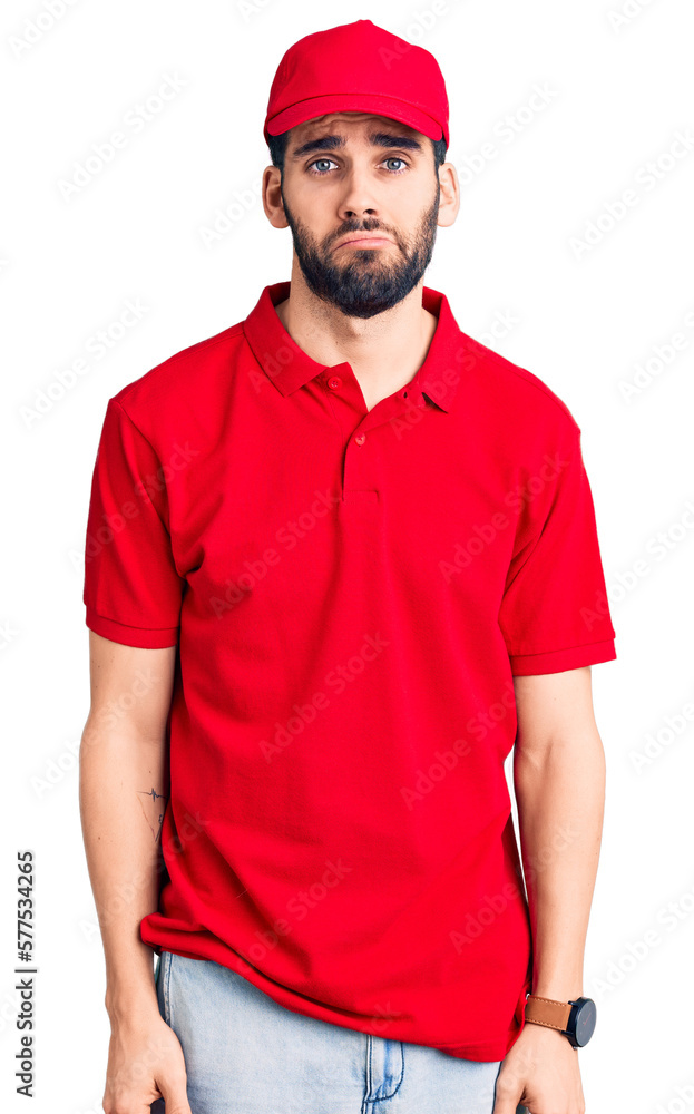 Young handsome man with beard wearing delivery uniform depressed and worry for distress, crying angry and afraid. sad expression. Young handsome man with beard wearing delivery uniform depressed and worry for distress, crying angry and afraid. sad expression.