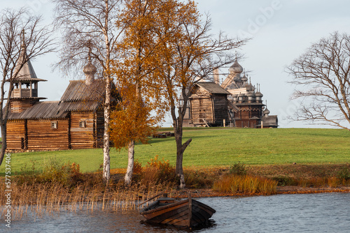 A monument of wooden architecture, a wooden church with many domes and wooden houses of peasants. Kizhi Island, Karelia, northern Russia.