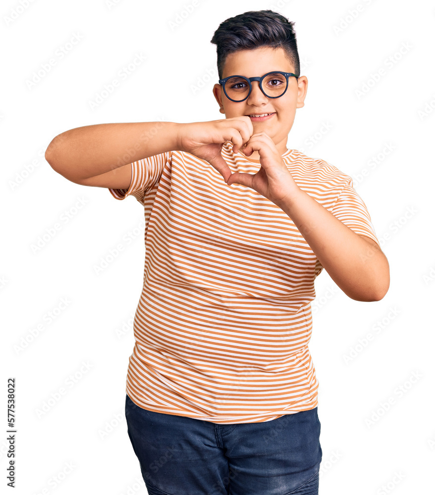 Fototapeta premium Little boy kid wearing casual clothes and glasses smiling in love doing heart symbol shape with hands. romantic concept.