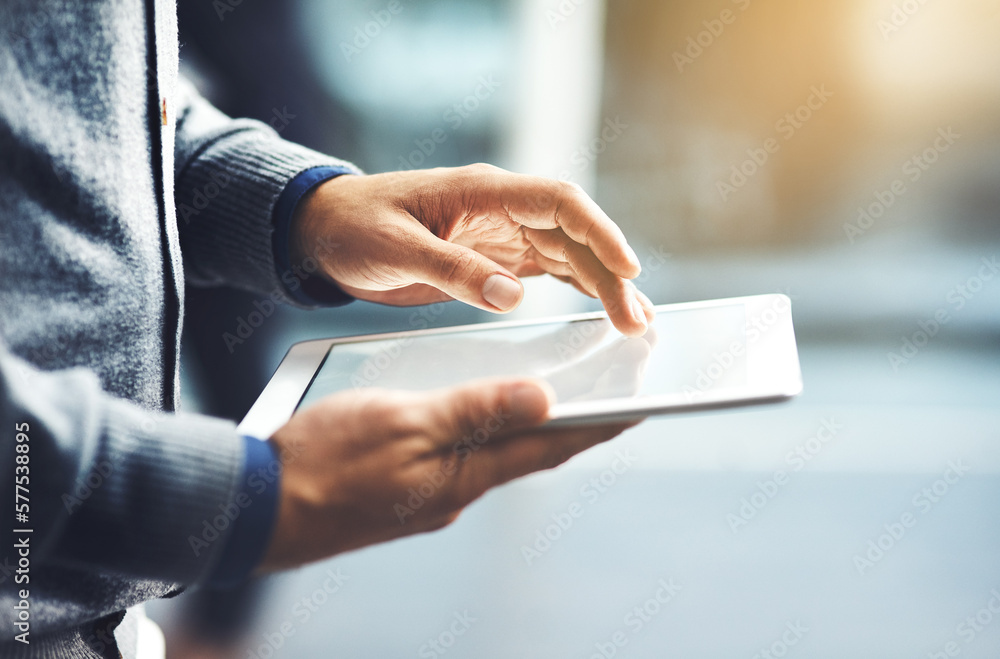 Take business to the next level through the world online. Closeup shot of an unrecognisable businessman using a digital tablet in an office. Take business to the next level through the world online. Closeup shot of an unrecognisable businessman using a digital tablet in an office.