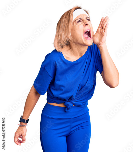 Young blonde woman wearing sportswear shouting and screaming loud to side with hand on mouth. communication concept.