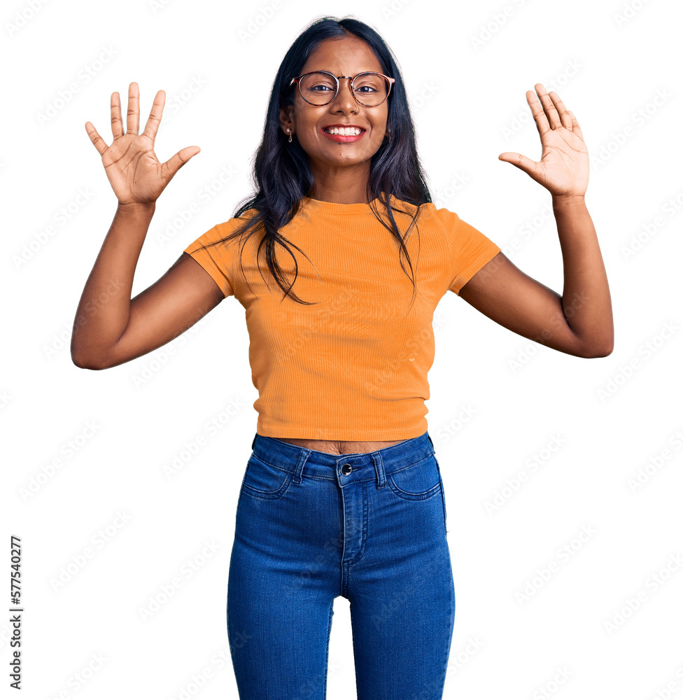 Young indian girl wearing casual clothes and glasses showing and pointing up with fingers number ten while smiling confident and happy. Young indian girl wearing casual clothes and glasses showing and pointing up with fingers number ten while smiling confident and happy.