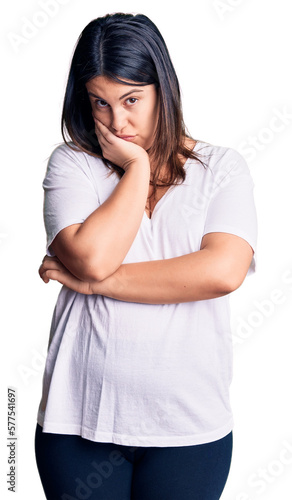 Young beautiful brunette woman wearing casual t-shirt thinking looking tired and bored with depression problems with crossed arms. © Krakenimages.com