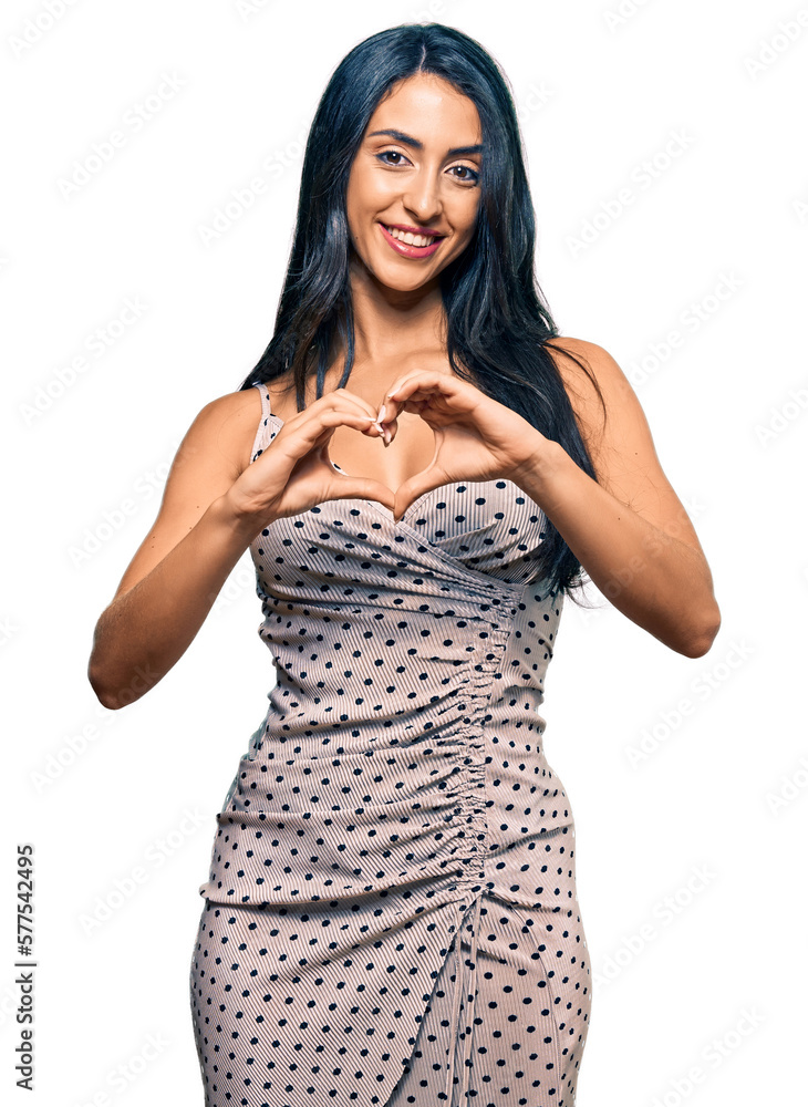 Beautiful hispanic woman wearing summer dress smiling in love showing heart symbol and shape with hands. romantic concept. Beautiful hispanic woman wearing summer dress smiling in love showing heart symbol and shape with hands. romantic concept.