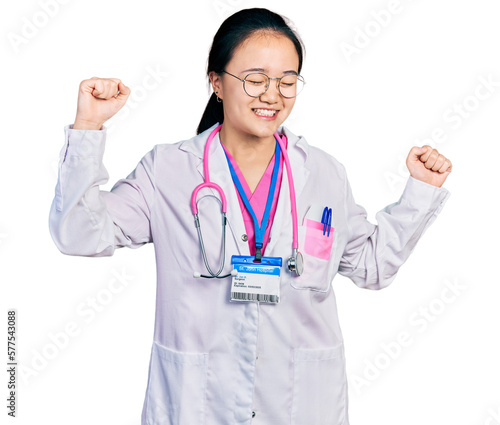 Young chinese woman wearing doctor uniform and stethoscope dancing happy and cheerful  smiling moving casual and confident listening to music