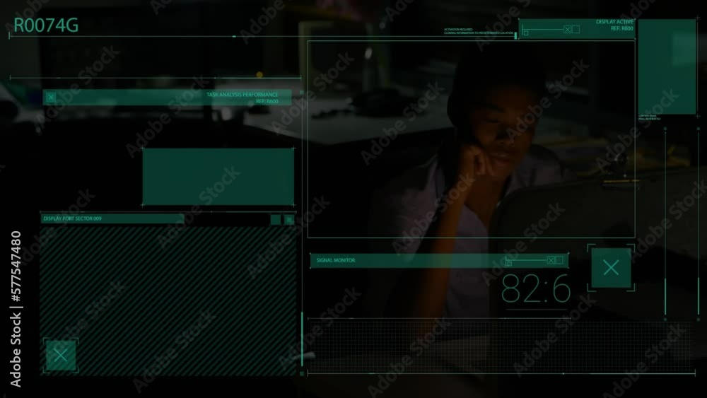 Animation of interface with data processing over african american woman working late at office Animation of interface with data processing over african american woman working late at office
