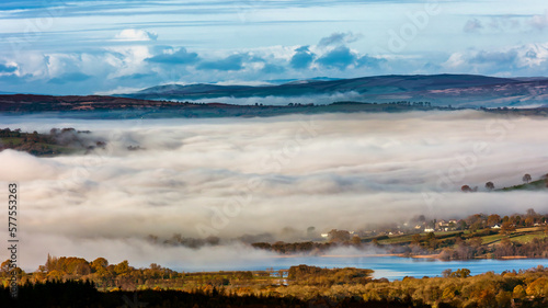 Fototapeta Naklejka Na Ścianę i Meble -  Low lying fog and cloud in a rural valley surrounded by farmland and fields (Brecon Beacons, Wales)