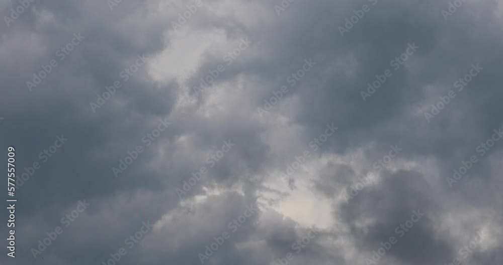 Clouds float quickly across the gloomy gray sky. Wind disperses the clouds on a rainy day Clouds float quickly across the gloomy gray sky. Wind disperses the clouds on a rainy day