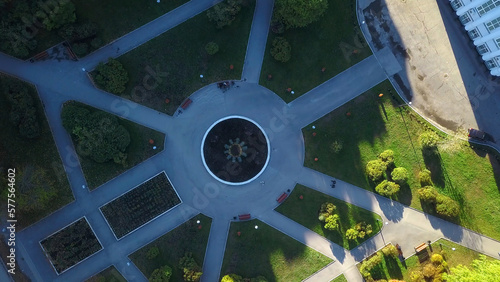 Top view of garden with fountain at manor. Clip. Pattern of paths with fountain in center of ancient chad. Old well-kept garden with fountain and manor house photo