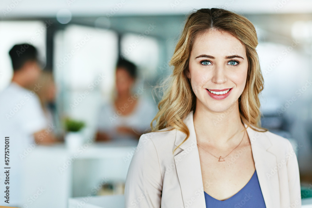 Im certain of my place in this business. Portrait of an ambitious young woman standing in a modern office with her colleagues in the background. - obrazy, fototapety, plakaty 