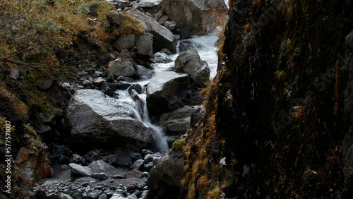 Cold mountains in winter. Creative. Huge stones on which small springs of cold water flow down and cold snow lies on the tops.