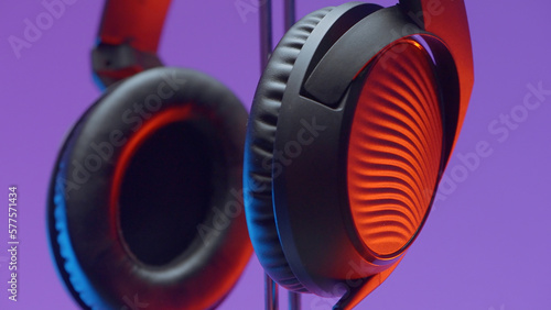 Black headphones. Action.Large headphones that shoot on a purple bright background.