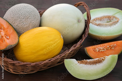 Many tasty ripe melons on wooden table