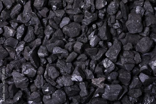 Pieces of black coal as background, top view