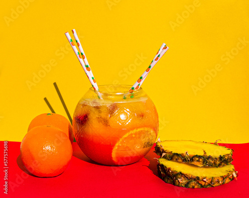 Fishbowl cocktail of strawberry, pineapple, mango, orange and fruit punch with pineapple slices