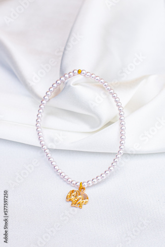 pearl necklace with white satin background
