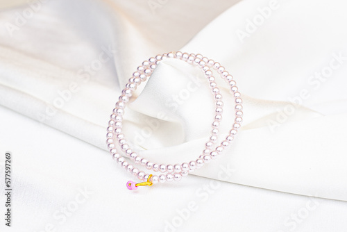 pearl necklace with white satin background