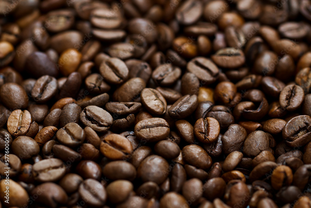 Roasted coffee beans close up background with central line focus Roasted coffee beans close up background with central line focus