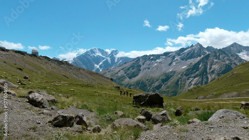 Aerial shot of Alps mountains and green grass covered slopes. Clip. Mountains, peaks, cliffs, rocks natural landscape.