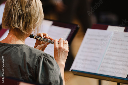 A musician playing the piccolo flute during in a wind band rehearsal photo