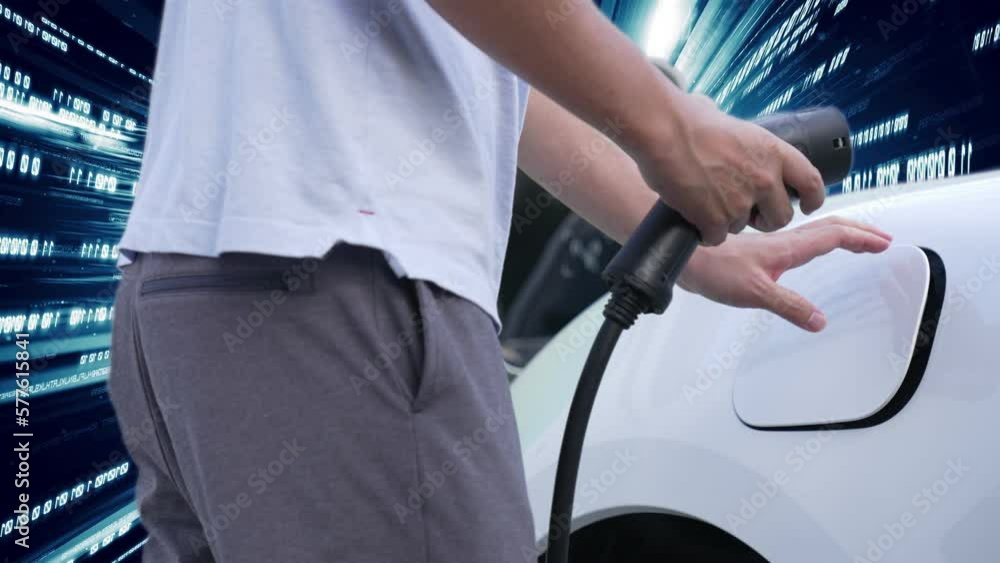 Progressive man charge electric car with power cable plug from charging ...