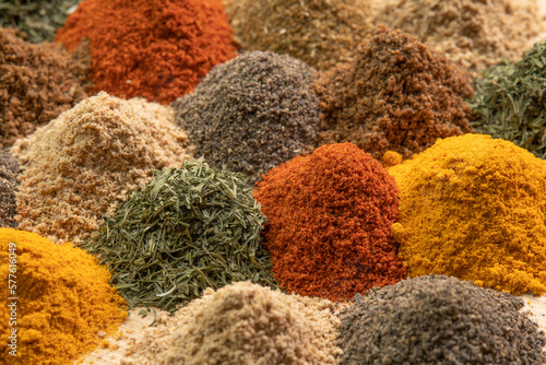 Spice and seasoning. Various fragrant spice market. Heap different Asian Spices lies on wooden background. Assortment spices and herbs for cooking
