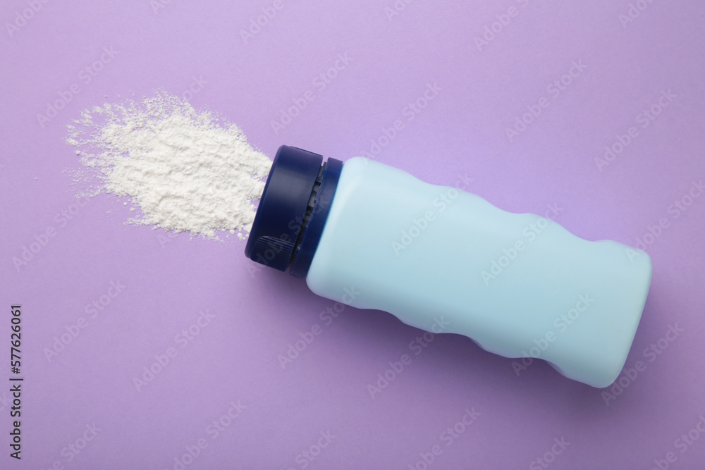 Baby powder on purple background. Baby cosmetics. Space for text Baby powder on purple background. Baby cosmetics. Space for text