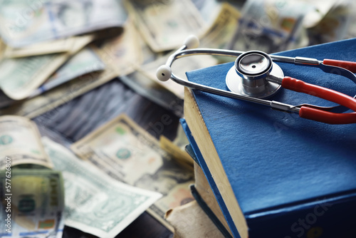 Financial analysis, auditing or business concept. Symbolic image of US Dollar banknotes with stethoscope.