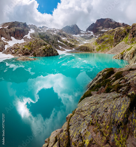 Fantastic alpine lake Lac Blanc surrounded by mountains in summer. Graian Alps, France, Europe.