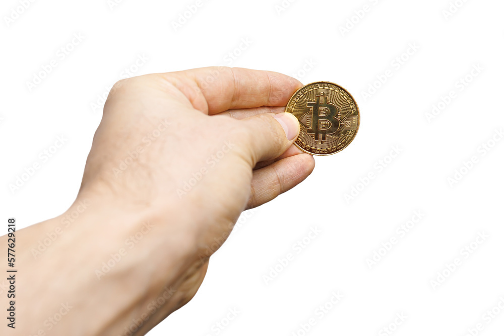 Fototapeta premium on a white background, a hand in fingers that are a gold coin Bitcoin