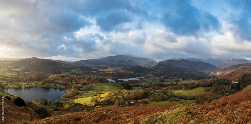 Stunning Winter sunrise golden hour landscape view from Loughrigg Fell across the countryside towards Langdale Pikes in the Lake District