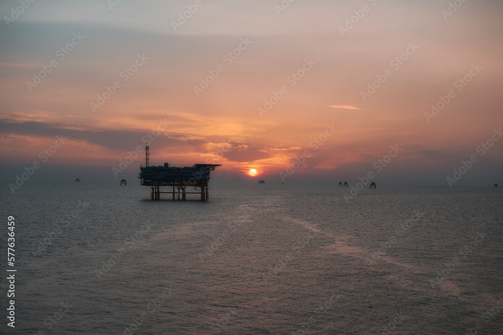 Electricity transformation station for wind turbines at sea at sunrise.