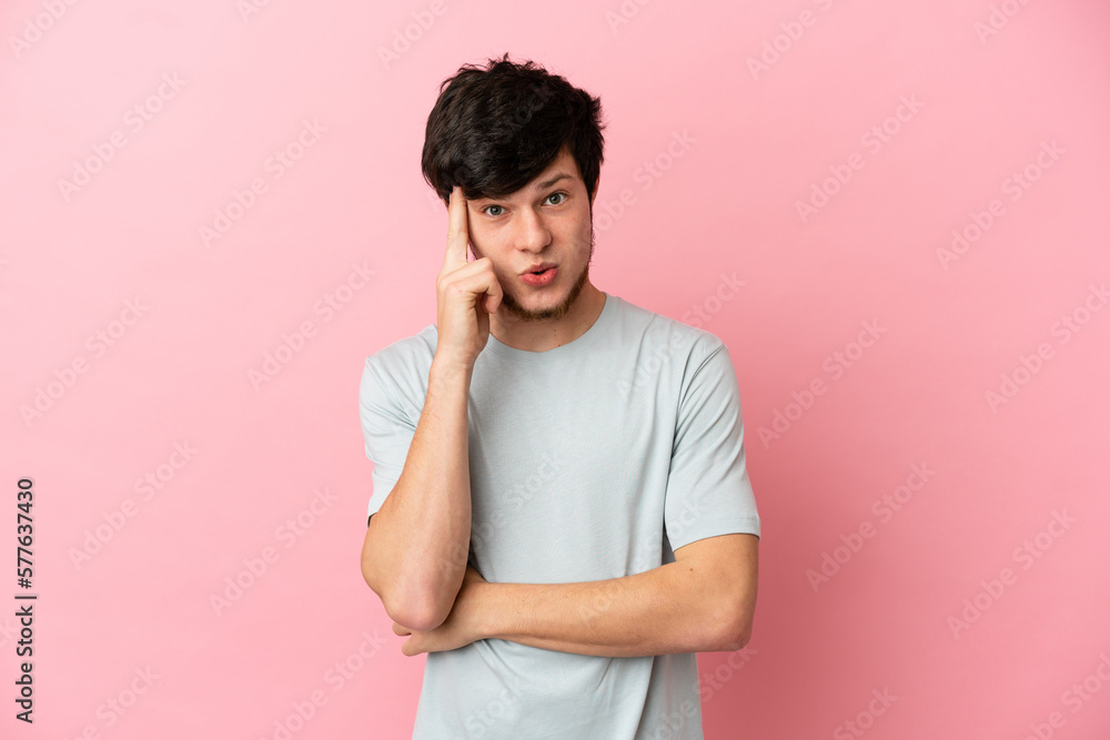 Young Russian man isolated on pink background thinking an idea Young Russian man isolated on pink background thinking an idea
