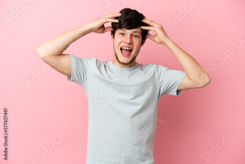 Young Russian man isolated on pink background with surprise expression