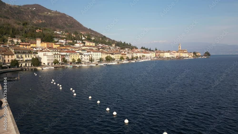 Europe, Italy, Brescia , Garda lake , Salo' drone aerial view of village with church and lake with blue water - Italian Republic from 1943 to 1945 during the reign of Benito Mussolini fascist Europe, Italy, Brescia , Garda lake , Salo' drone aerial view of village with church and lake with blue water - Italian Republic from 1943 to 1945 during the reign of Benito Mussolini fascist