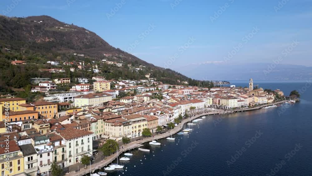Europe, Italy, Brescia , Garda lake , Salo' drone aerial view of village with church and lake with blue water - Italian Republic from 1943 to 1945 during the reign of Benito Mussolini fascist Europe, Italy, Brescia , Garda lake , Salo' drone aerial view of village with church and lake with blue water - Italian Republic from 1943 to 1945 during the reign of Benito Mussolini fascist