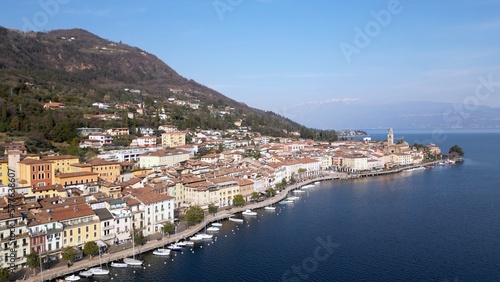 Europe, Italy, Brescia , Garda lake , Salo' drone aerial view of  village with church and lake with blue water - Italian  Republic from 1943 to 1945 during the reign of Benito Mussolini fascist 