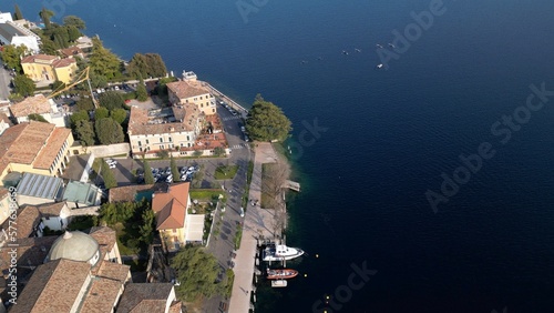 Europe, Italy, Brescia , Garda lake , Salo' drone aerial view of village with church and lake with blue water - Italian Republic from 1943 to 1945 during the reign of Benito Mussolini fascist 