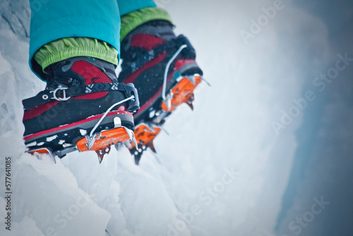 Boots of an ice climber on the wall.